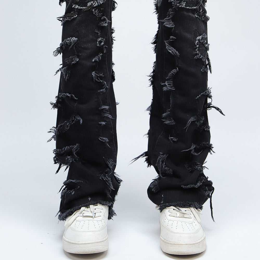 SAZI SZ-01 jean hem detail, frayed raw-edge panels stacking over white sneakers