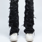 SAZI SZ-01 jean hem detail, frayed raw-edge panels stacking over white sneakers