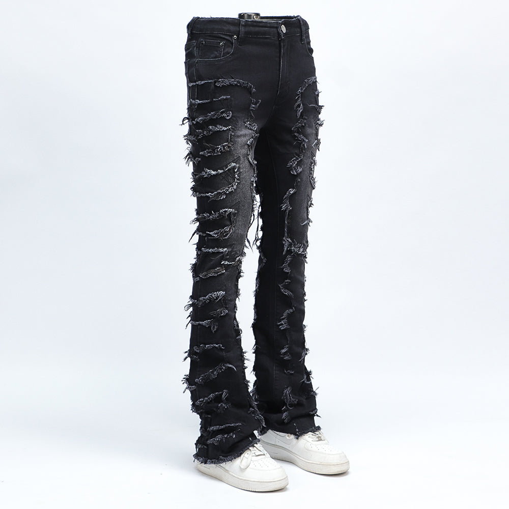 SAZI SZ-01 jean three-quarter view showing the stacked flare over sneakers